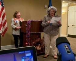 Chaplain leading prayer at meeting